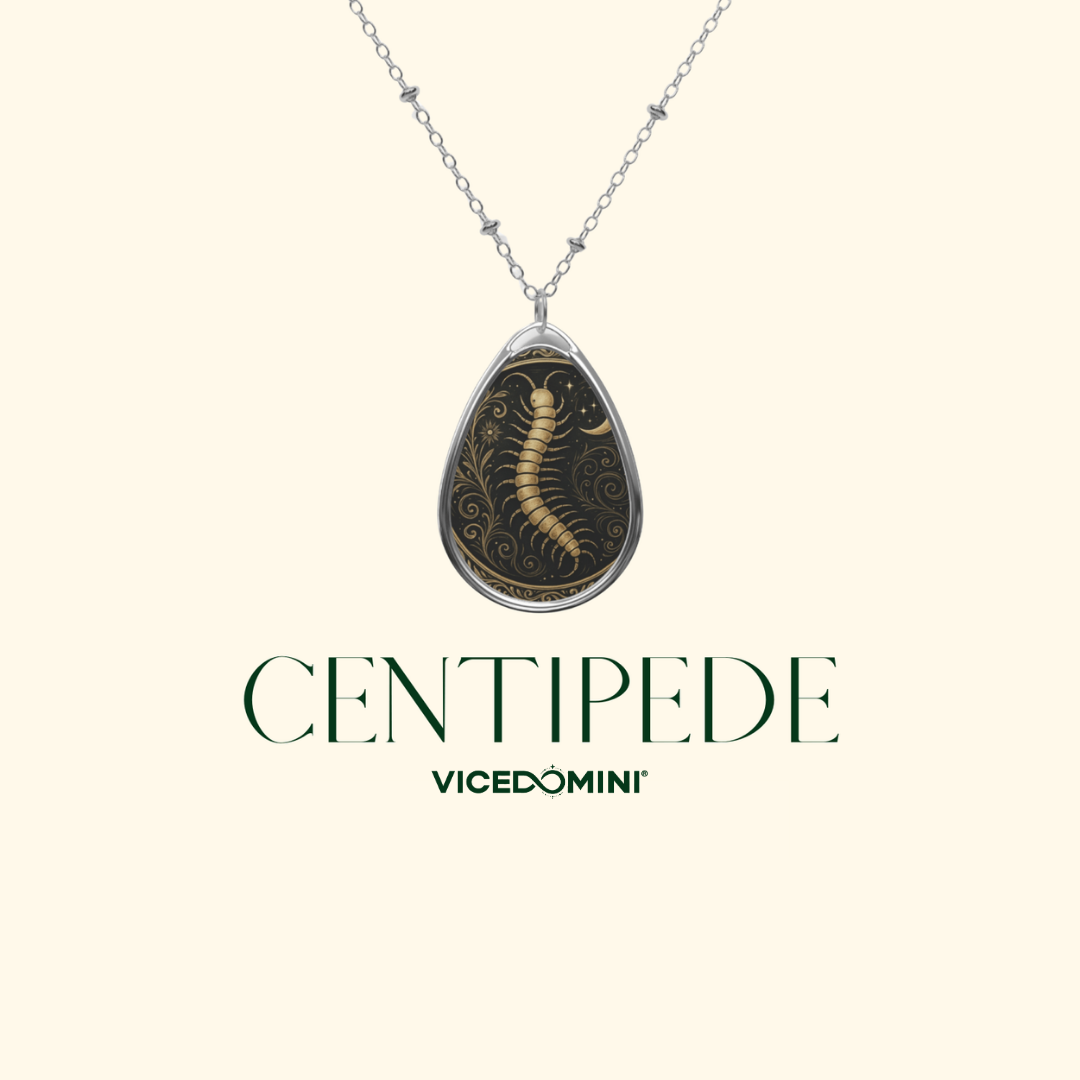 Close-up of the Centipede Spirit Animal Necklace with intricate gold details on a black background, labeled "CENTIPEDE – VICEDOMINI."