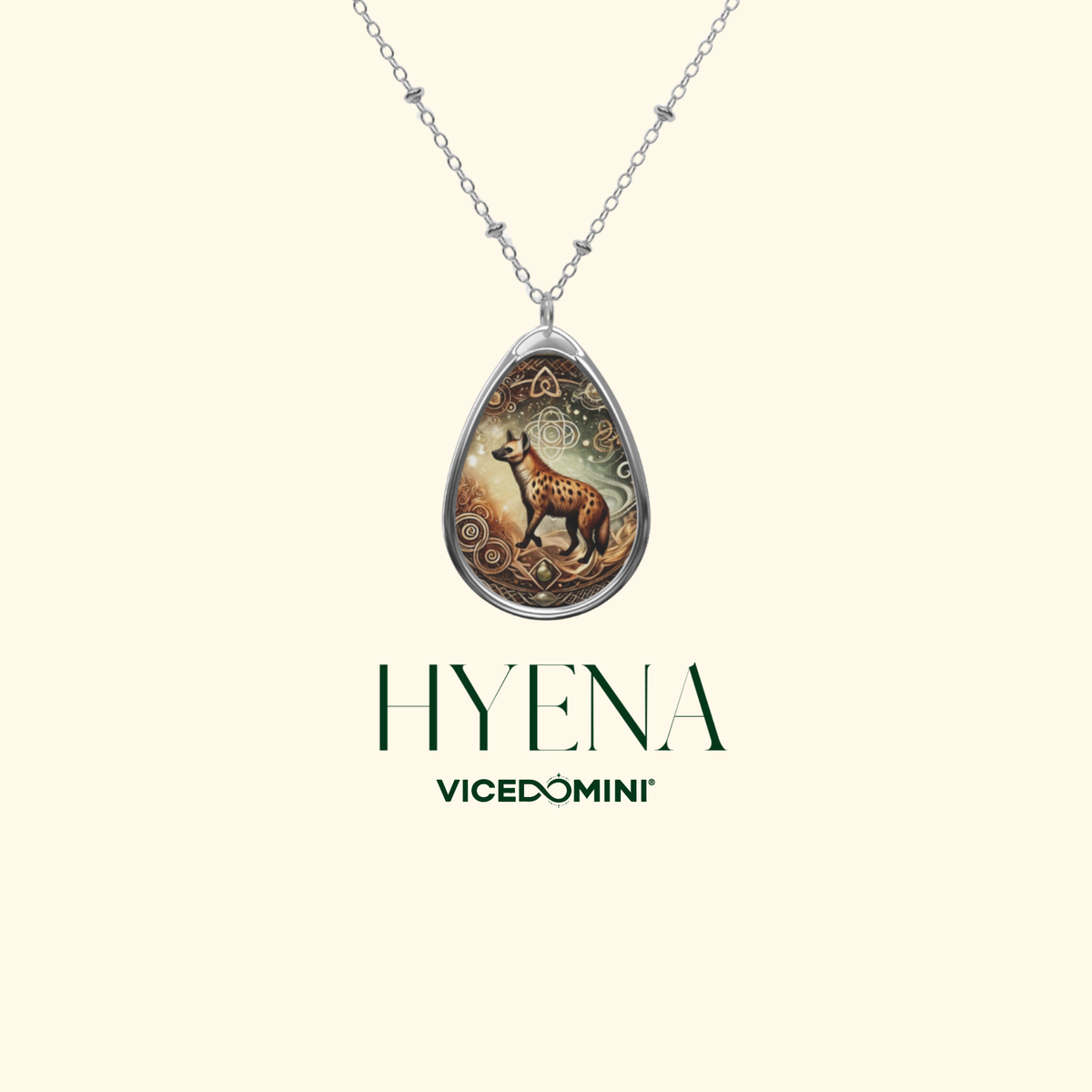 A silver teardrop pendant necklace featuring an illustrated hyena with a giraffe on a warm-toned background, shown on a light cream background with the text 'HYENA VICEDOMINI' below.