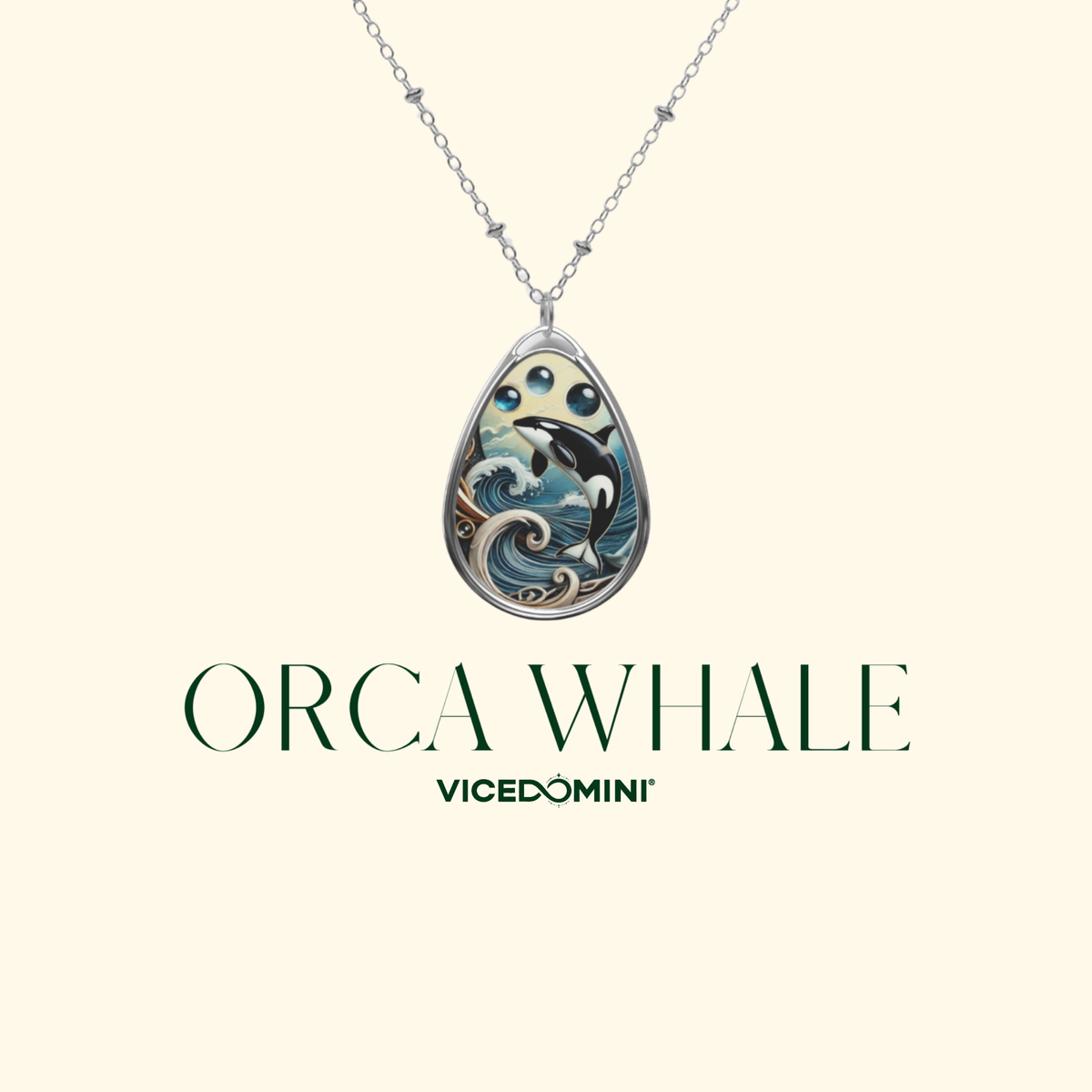 A Vicedomini ORCA WHALE pendant necklace featuring a silver teardrop-shaped pendant with an intricate illustration of an orca and ocean waves, shown on a light cream background with the brand name below.