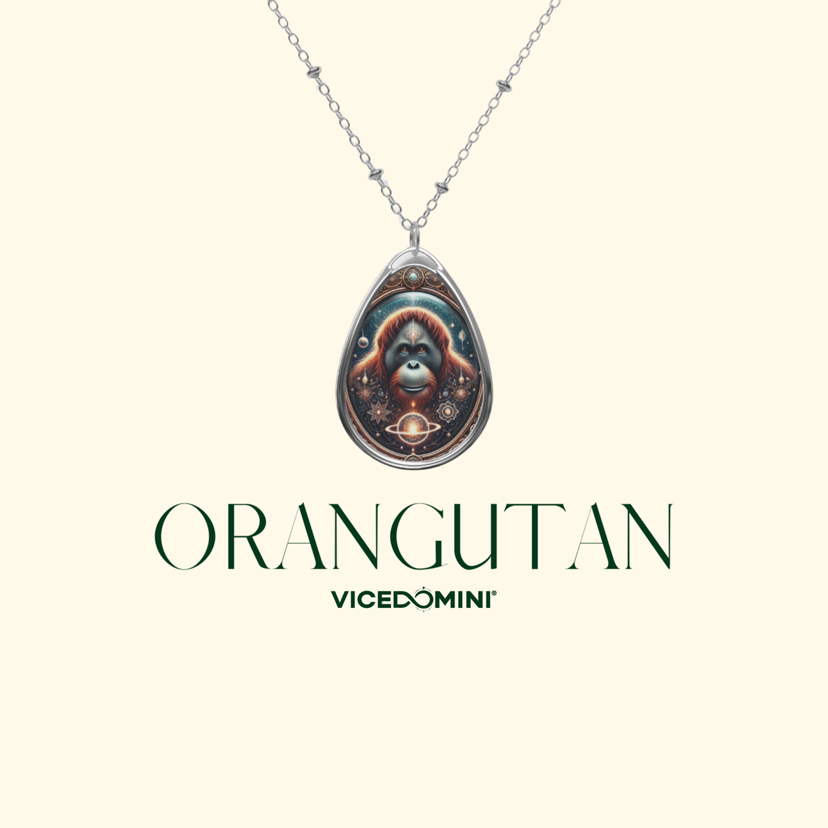 A silver teardrop pendant necklace featuring a detailed illustration of an orangutan, displayed on a cream background with the text 'ORANGUTAN' and 'VICEDOMINI' underneath.