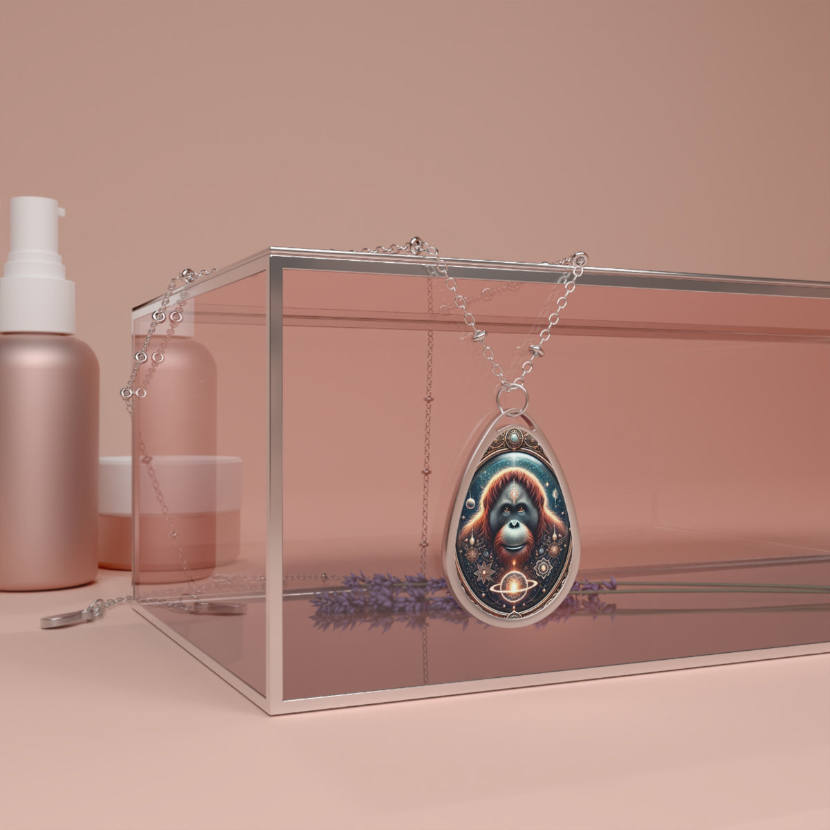 The pendant drapes over a transparent glass box, with skincare bottles and lavender flowers in the background. The orangutan design is highlighted with cosmic elements, intricate filigree, and warm earthy tones.