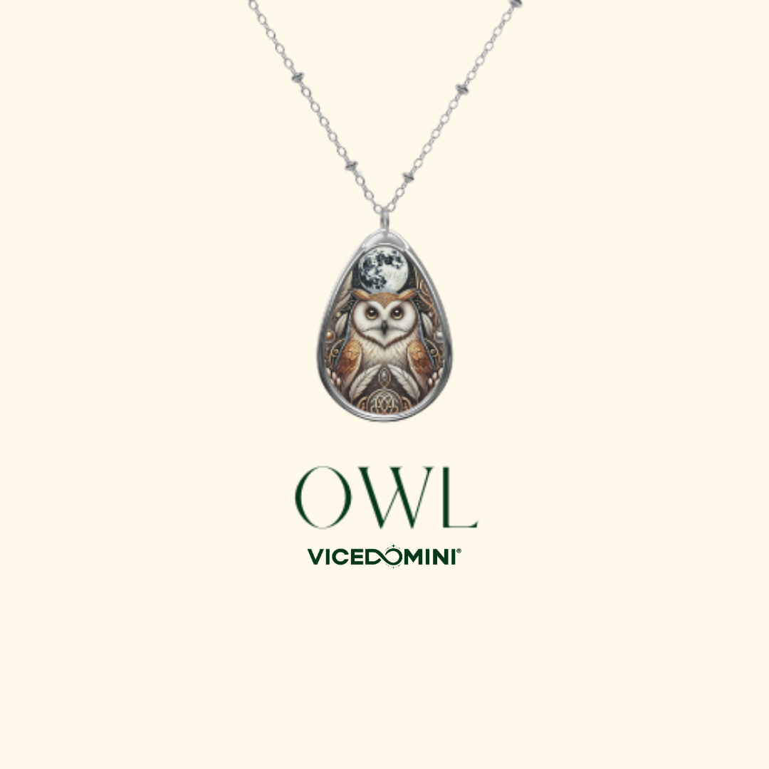 A silver owl pendant necklace with a detailed owl illustration, shown on a light cream background with the brand name 'OWL Vicedomini' printed below.