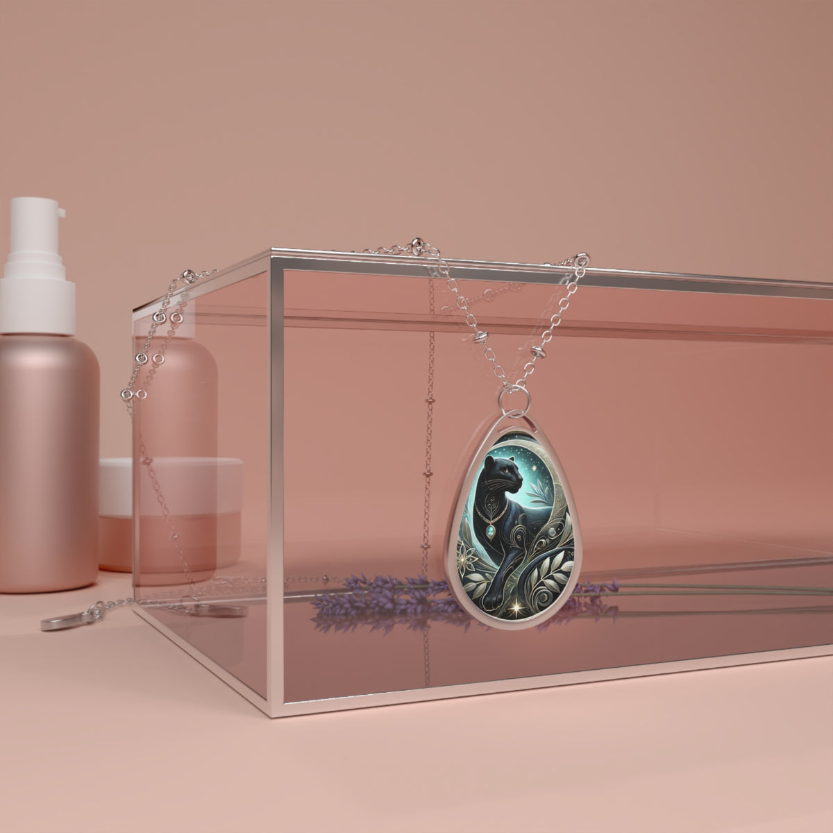 A silver necklace with a teardrop-shaped pendant featuring an artistic illustration of a black panther surrounded by celestial patterns and nature-inspired details, displayed elegantly on a pink backdrop.