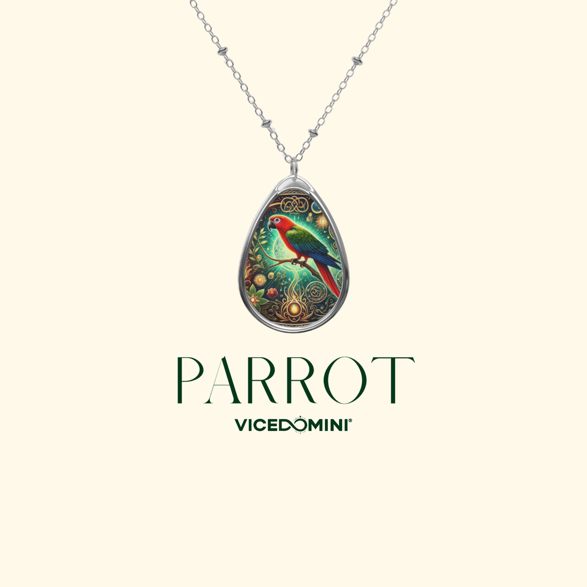 A teardrop-shaped pendant necklace featuring a colorful parrot illustration on a silver-toned chain, shown against a light cream background with the brand name 'PARROT' and 'VICEDOMINI' printed below.
