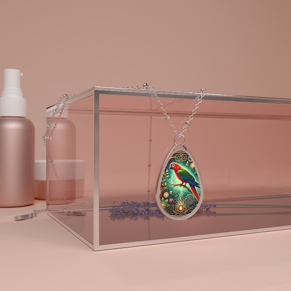The parrot necklace draped over a transparent glass box, surrounded by lavender sprigs and soft pink-toned cosmetics containers. The pendant's rich colors and filigree details stand out against the muted background.