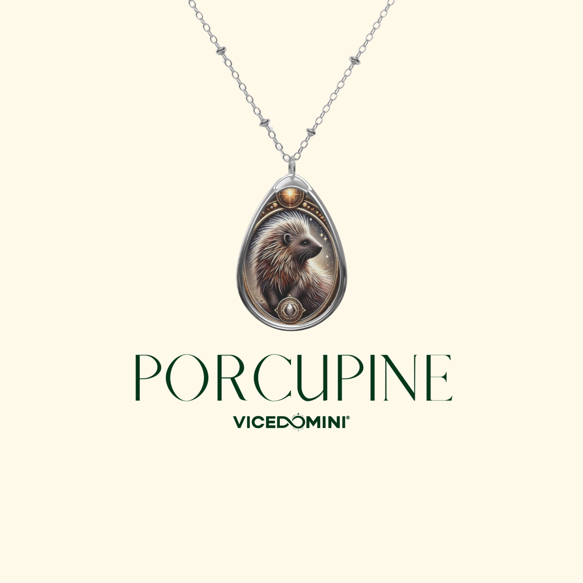 A teardrop-shaped pendant necklace featuring a detailed illustration of a porcupine, suspended from a silver chain against a light cream background. Below the necklace, the brand name 'VICEDOMINI' and the collection name 'PORCUPINE' are printed in dark green.