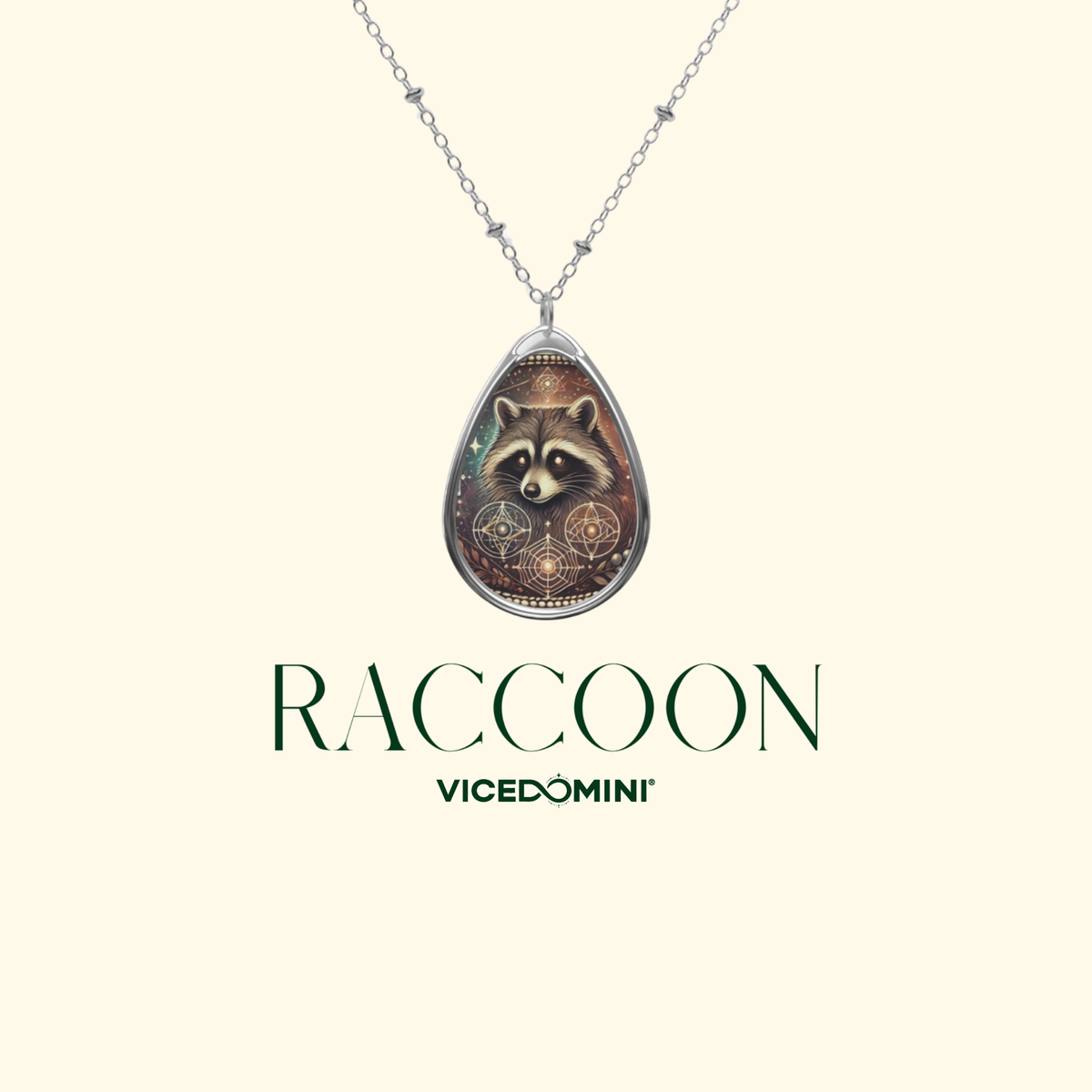 Elegant raccoon pendant necklace suspended from a delicate silver chain, displayed on a light beige background with the text 'RACCOON' and 'VICEDOMINI' in a modern font.