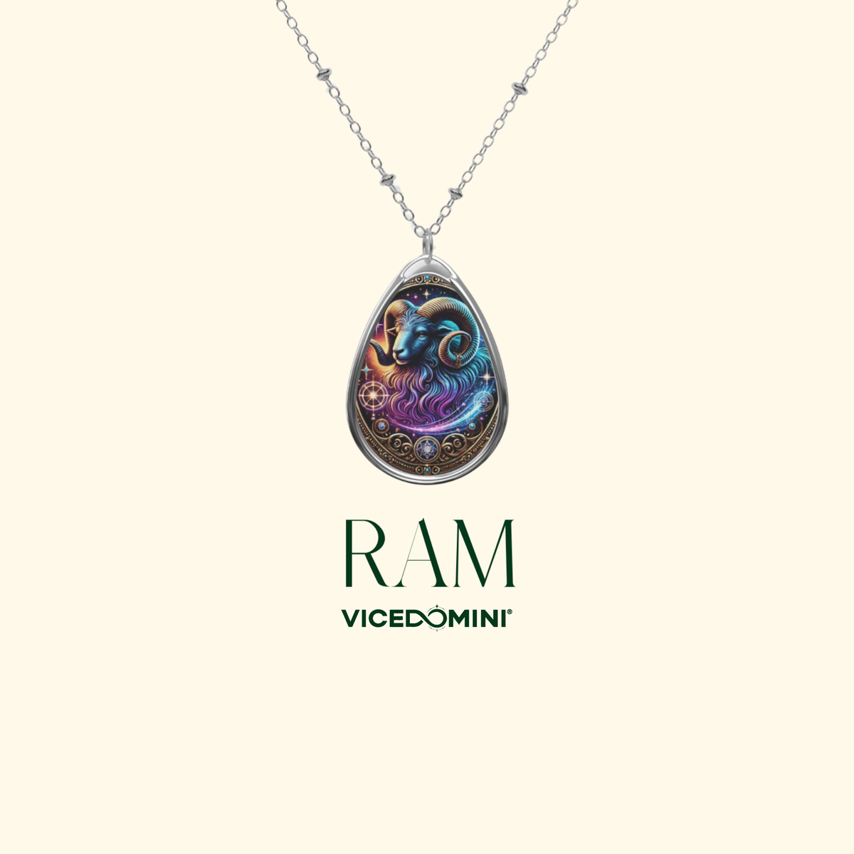 A detailed ram-themed pendant necklace with intricate gold and celestial elements, suspended from a silver chain. The design features a mystical, cosmic-inspired illustration of a ram in blue and purple tones. The text 'RAM' and 'VICEDOMINI' are displayed beneath the pendant on a minimalist cream-colored background.