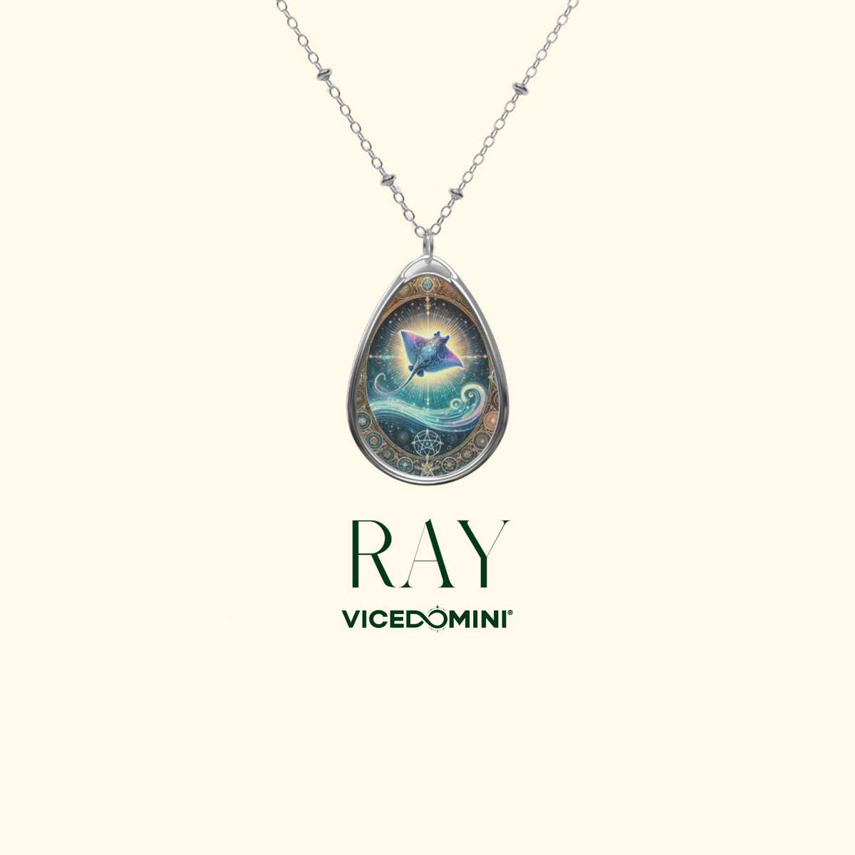 A silver pendant necklace showcasing a mystical stingray design with an ethereal glow, set against a swirling ocean and golden filigree detailing. The jewelry is displayed against a clean, neutral background with the words "RAY" and "VICEDOMINI" in elegant typography.
