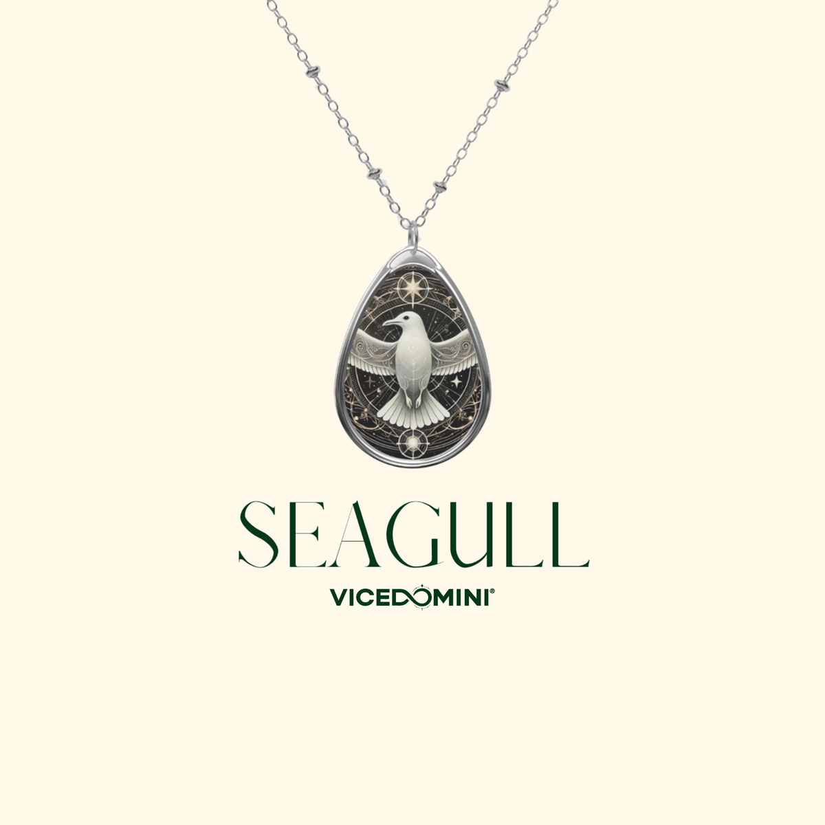 A close-up of the Seagull Necklace against a light beige background. The pendant showcases a detailed seagull with outstretched wings, enclosed in an ornate, celestial-inspired border. The words "SEAGULL" and "VICEDOMINI" are written in a refined font.