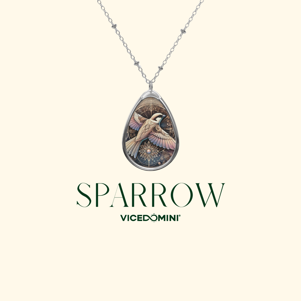A silver teardrop pendant necklace featuring a detailed illustration of a sparrow in flight, displayed on a cream background with the brand name 'SPARROW' and 'VICEDOMINI' printed below.