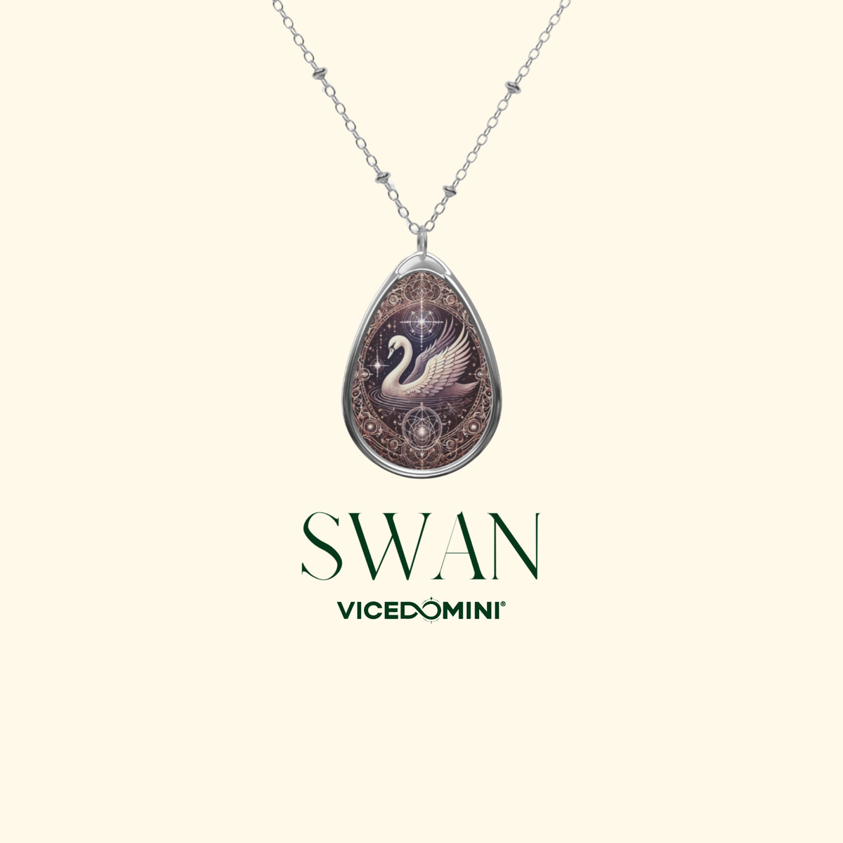 A Vicedomini Swan pendant necklace featuring a detailed swan illustration on a brown textured background, suspended from a silver chain against a light cream background with the brand name 'Vicedomini' printed below.