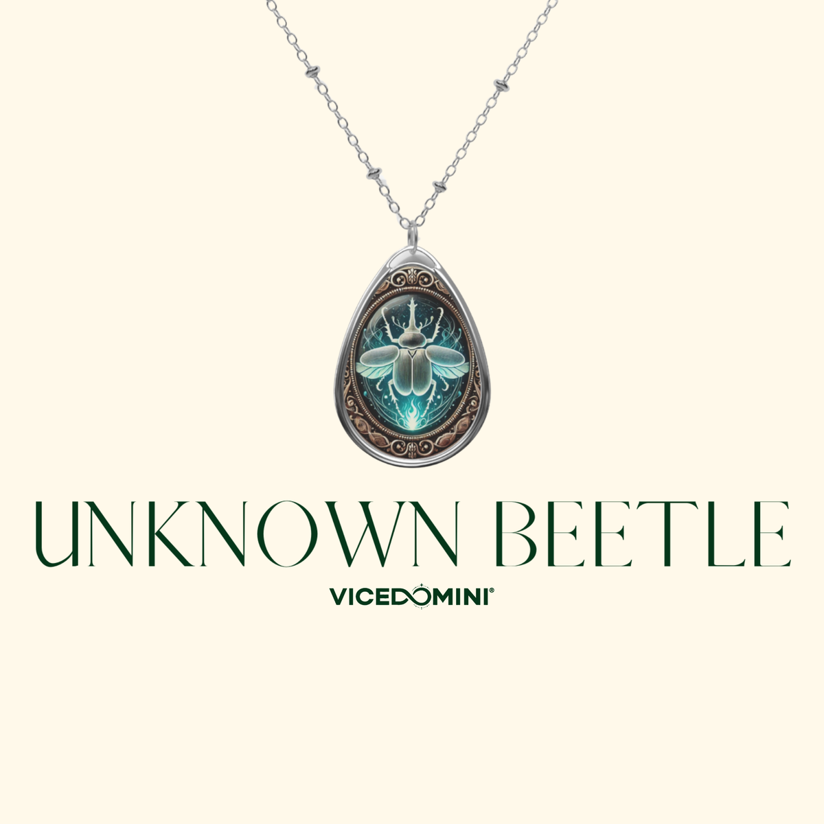 A teardrop-shaped pendant necklace featuring a beetle illustration with glowing teal and green tones inside a silver-toned frame, suspended from a delicate silver chain. The pendant is centered on a pale cream background with the text 'UNKNOWN BEETLE' and 'VICEDOMINI' below.