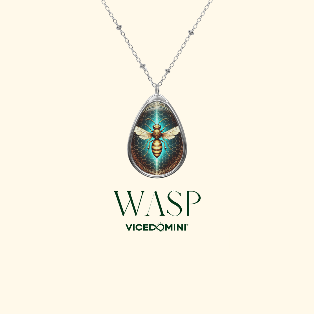 A close-up of the wasp pendant necklace on a plain light background. The intricate wasp design, set within a golden honeycomb pattern, stands out, with the text ‘WASP’ and ‘VICEDOMINI’ elegantly placed underneath.