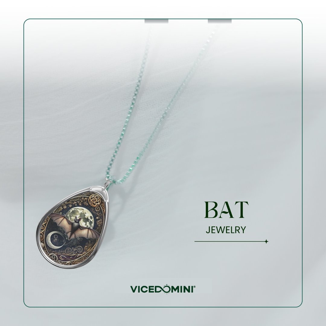 A teardrop-shaped pendant necklace from Vicedomini featuring a bat and moon design with a light blue chain, displayed on a light gray background with 'BAT JEWELRY' and 'VICEDOMINI' text.