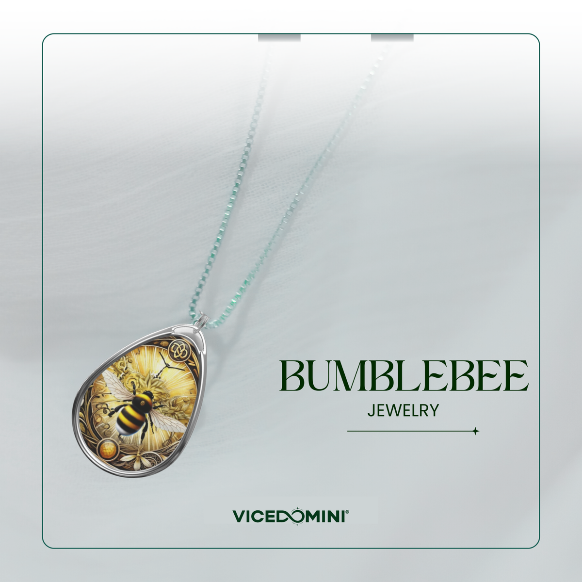 A Vicedomini Bumblebee Jewelry pendant necklace featuring a detailed bumblebee and flower design inside a teardrop-shaped silver frame, suspended on a delicate mint green chain against a light gray textured background with brand text.