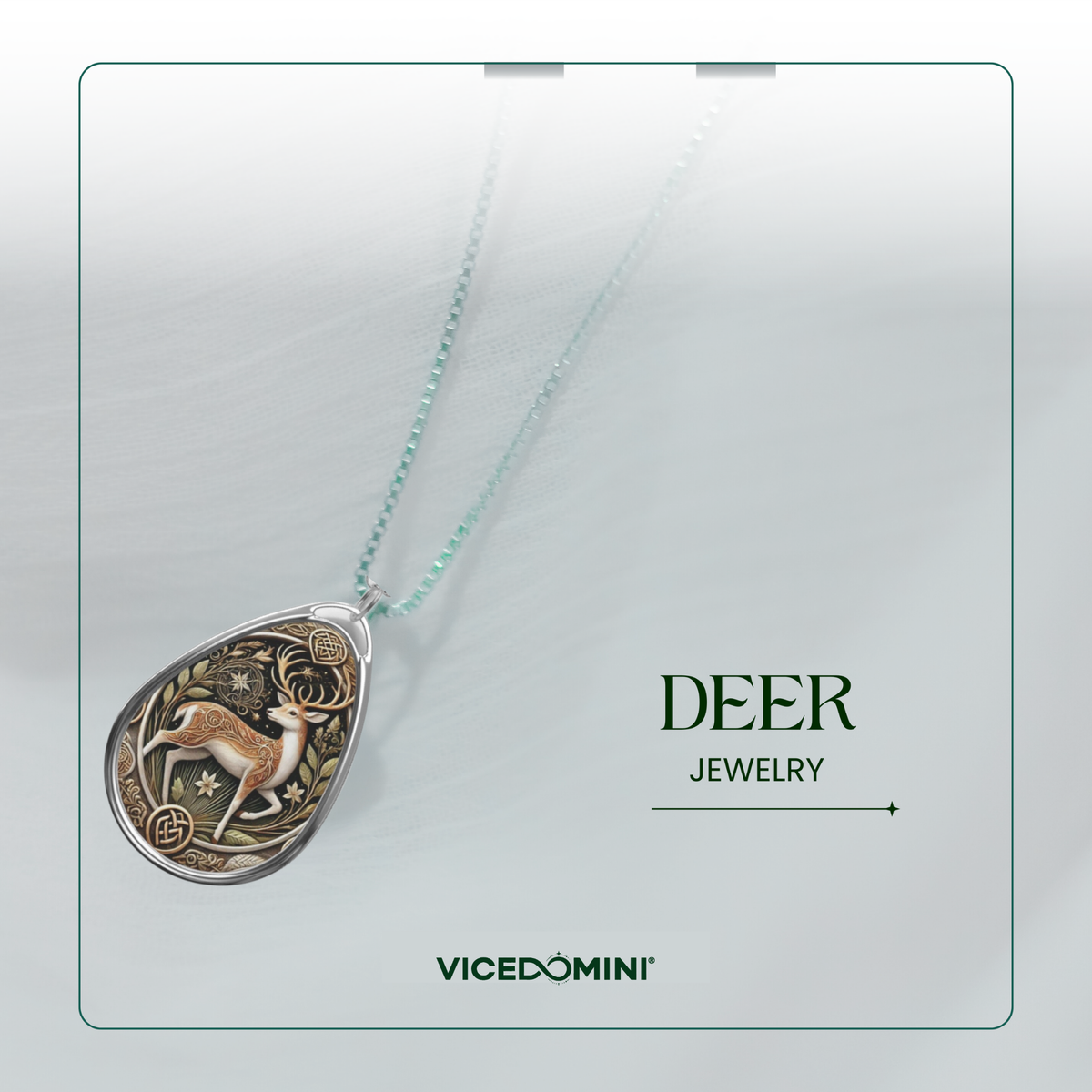 A teardrop-shaped pendant necklace featuring an engraved deer design in gold and silver tones, suspended from a delicate mint green chain. The pendant is displayed on a light gray background with a thin green border, alongside the text 'DEER JEWELRY' and the brand name 'VICEDOMINI'.
