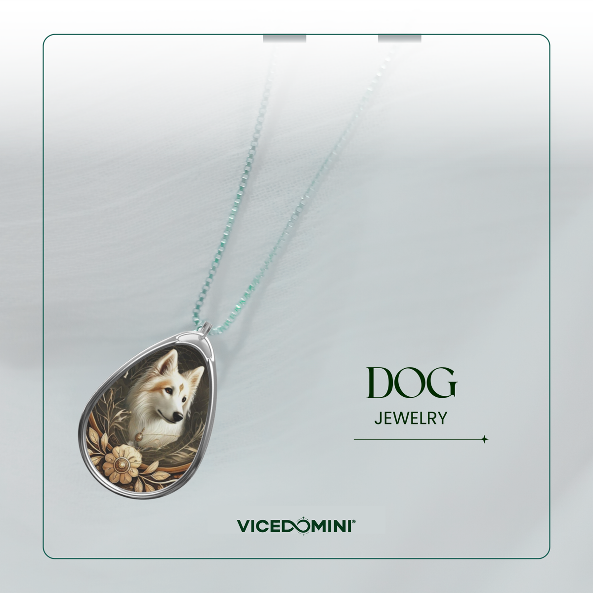 A teardrop-shaped pendant necklace featuring a detailed illustration of a white dog surrounded by warm-toned floral elements, suspended from a delicate mint green chain. The pendant is displayed on a light gray textured background with the text 'DOG JEWELRY' and the brand 'VICEDOMINI' printed on the right.