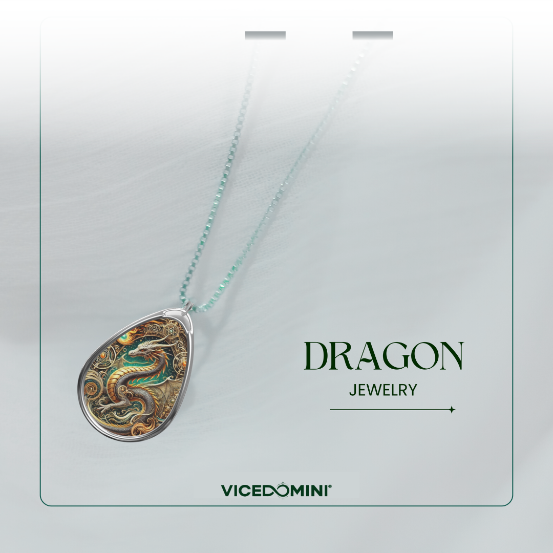 A Vicedomini dragon jewelry pendant necklace displayed on a light gray card. The pendant is a silver teardrop shape featuring a highly detailed, colorful dragon design in gold, green, and brown tones.