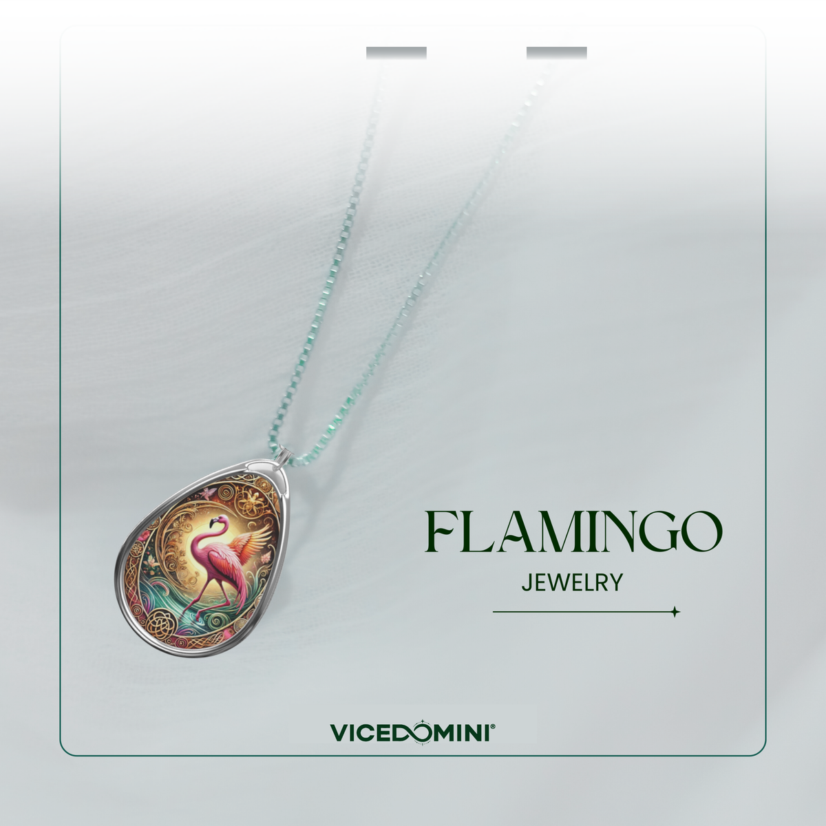 A Vicedomini jewelry necklace featuring a teardrop-shaped pendant with a colorful flamingo illustration, suspended from a light mint-green chain, presented on a white display card labeled 'FLAMINGO JEWELRY' and 'VICEDOMINI'.