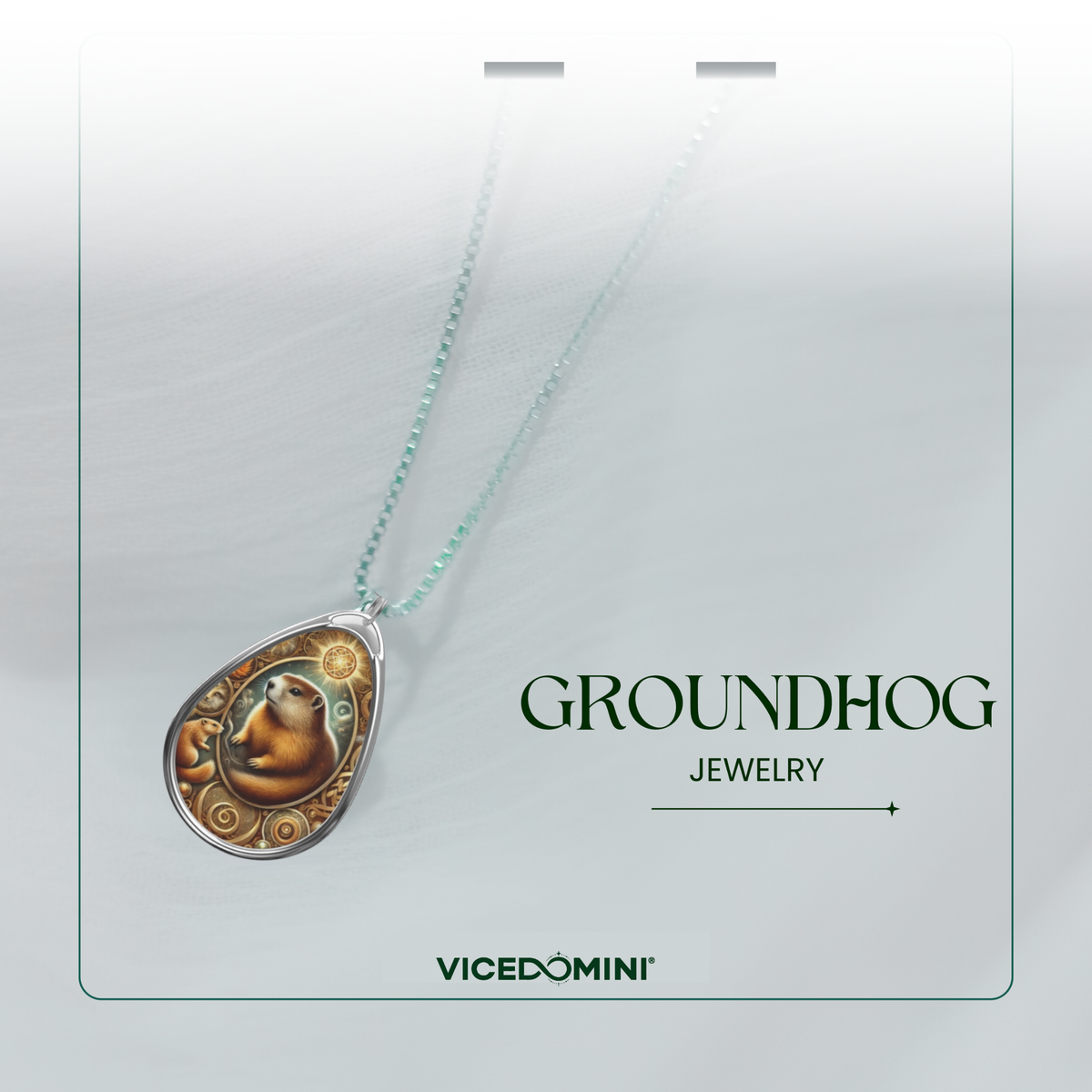 A teardrop-shaped pendant necklace featuring a detailed groundhog illustration in warm brown and gold tones, suspended from a delicate light blue-green chain. The necklace is presented on a white display card with the text 'GROUNDHOG JEWELRY' and the brand 'VICEDOMINI' printed below.