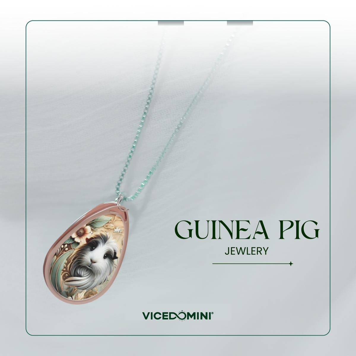 Teardrop-shaped pendant necklace featuring an illustrated Guinea pig on a rose gold-toned background, suspended from a light mint-green chain. The pendant is displayed on a clean, light gray background card with the text 'GUINEA PIG JEWELRY' and the brand 'VICEDOMINI'.