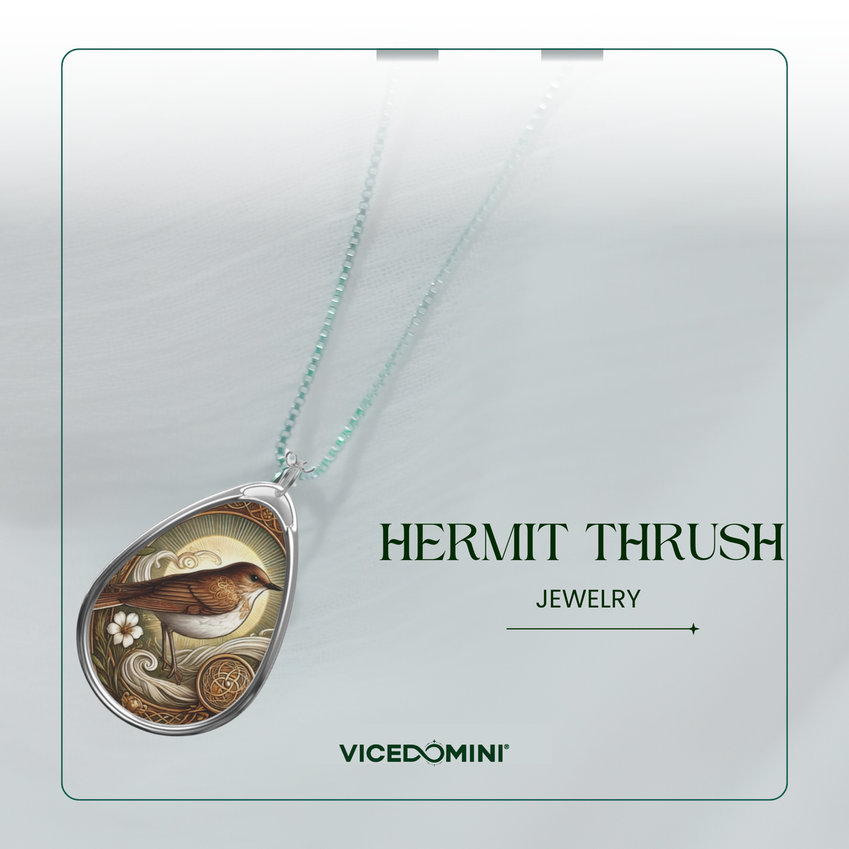 A teardrop-shaped pendant necklace featuring a detailed illustration of a hermit thrush bird on a light mint green chain, presented on a clean white background with branding text 'HERMIT THRUSH JEWELRY' and 'VICEDOMINI'.