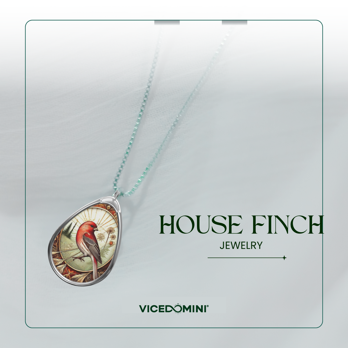 A teardrop-shaped pendant necklace featuring a detailed illustration of a red house finch on a light background, suspended from a delicate mint green chain. The pendant is displayed on a clean, light gray background card with the text 'HOUSE FINCH JEWELRY' and the brand 'VICEDOMINI'.