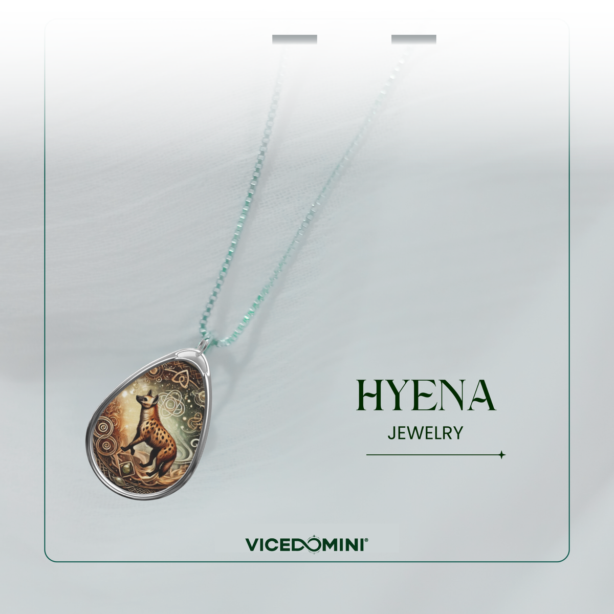 A teardrop-shaped pendant necklace on a fine mint-green chain, featuring an Art Deco style illustration of a hyena. The pendant has a silver-toned border and a detailed illustration with warm brown, gold, and orange tones.
