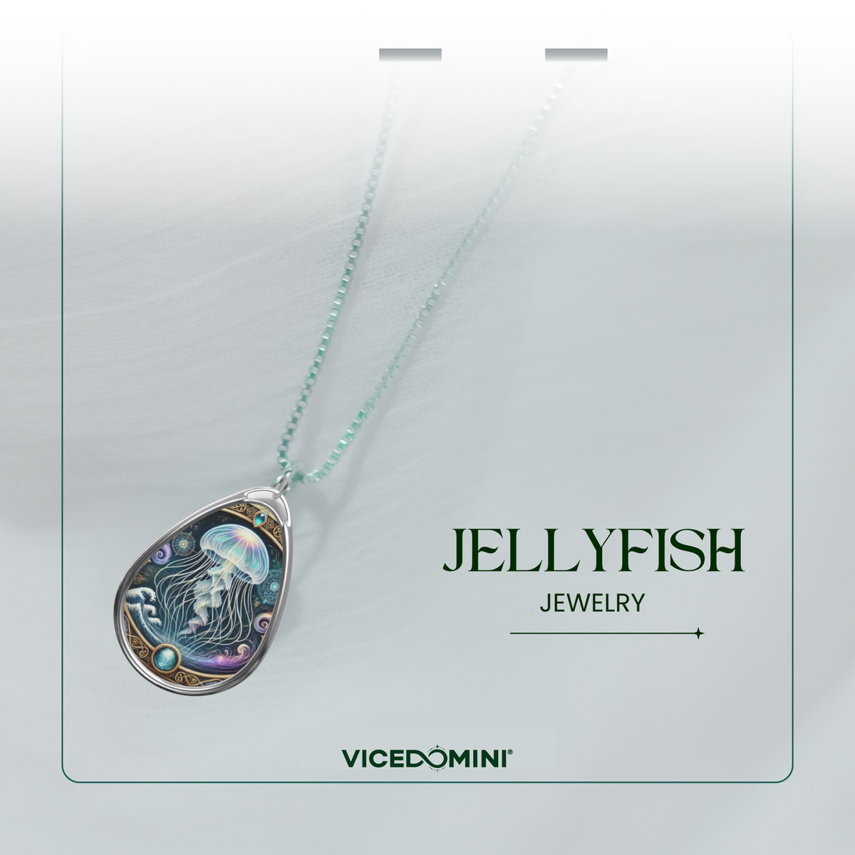 A teardrop-shaped pendant necklace featuring a detailed jellyfish illustration with iridescent blue, purple, and green tones, suspended from a delicate light blue-green chain. The necklace is presented on a white display card with the text 'JELLYFISH JEWELRY' and the brand 'VICEDOMINI'.
