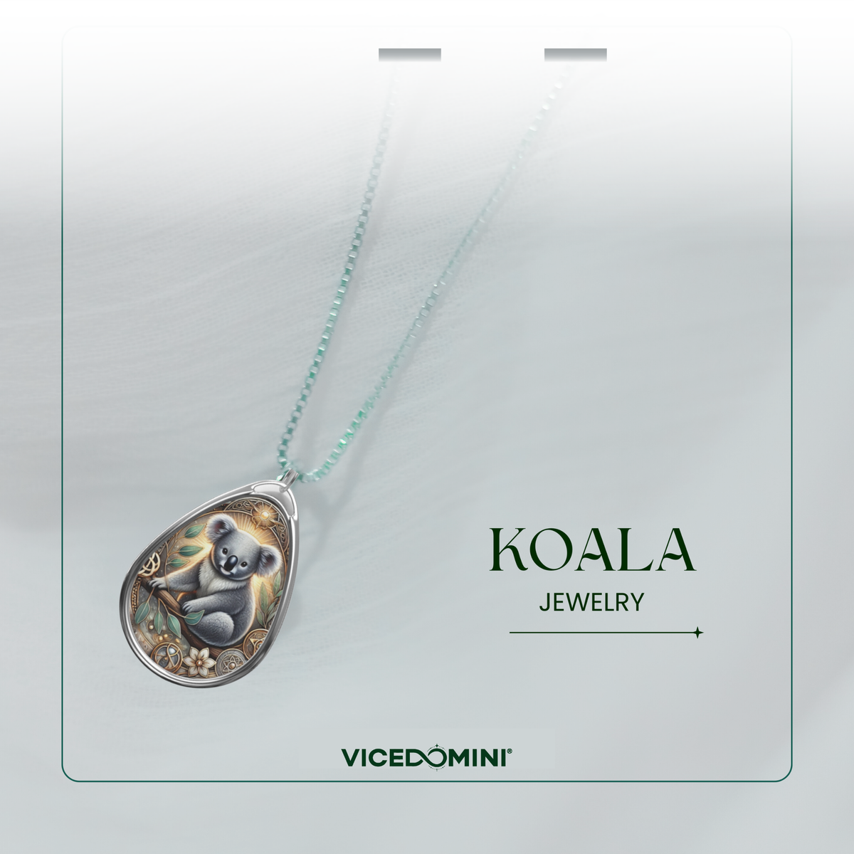 A Vicedomini Koala Jewelry pendant necklace featuring a detailed painted koala on a silver teardrop-shaped pendant, suspended from a delicate mint green chain, presented on a light gray textured card.