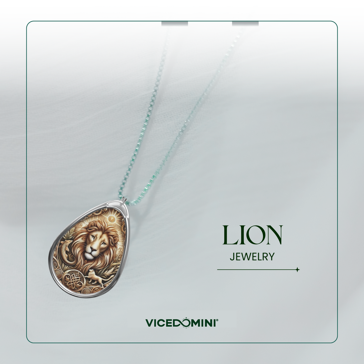 A teardrop-shaped pendant necklace featuring an embossed lion face and circular floral motif, suspended on a delicate mint green chain. The pendant is displayed on a light gray textured background with a thin green border, alongside the text 'LION JEWELRY' and the brand name 'VICEDOMINI'.