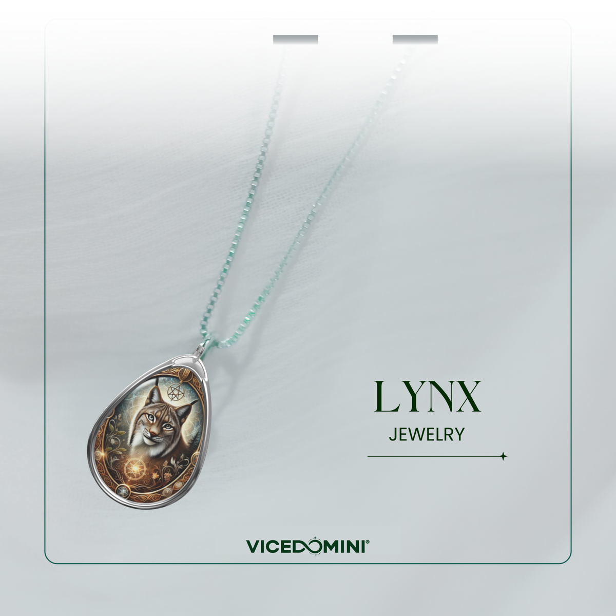 A teardrop-shaped pendant necklace featuring an illustrated lynx cat with a glowing amber orb, suspended on a delicate mint green chain. The pendant is displayed on a white card with the text 'LYNX JEWELRY' and the brand 'VICEDOMINI' printed below.