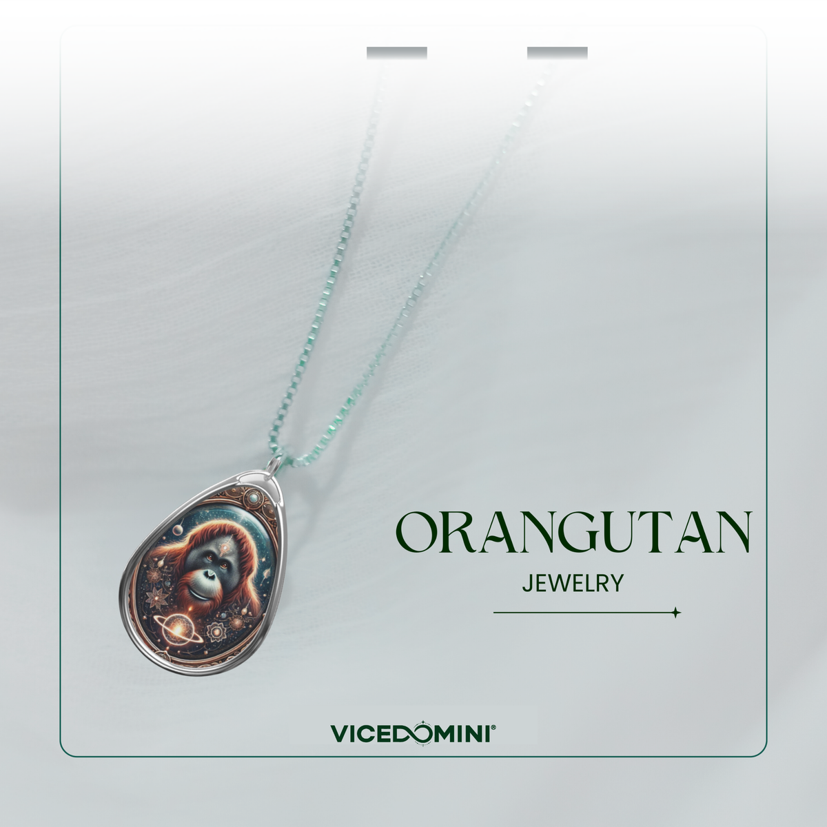 A teardrop-shaped pendant necklace with a colorful orangutan illustration, hanging from a light mint-green chain on a white display card. The card features the text 'ORANGUTAN JEWELRY' and the brand 'VICEDOMINI'.