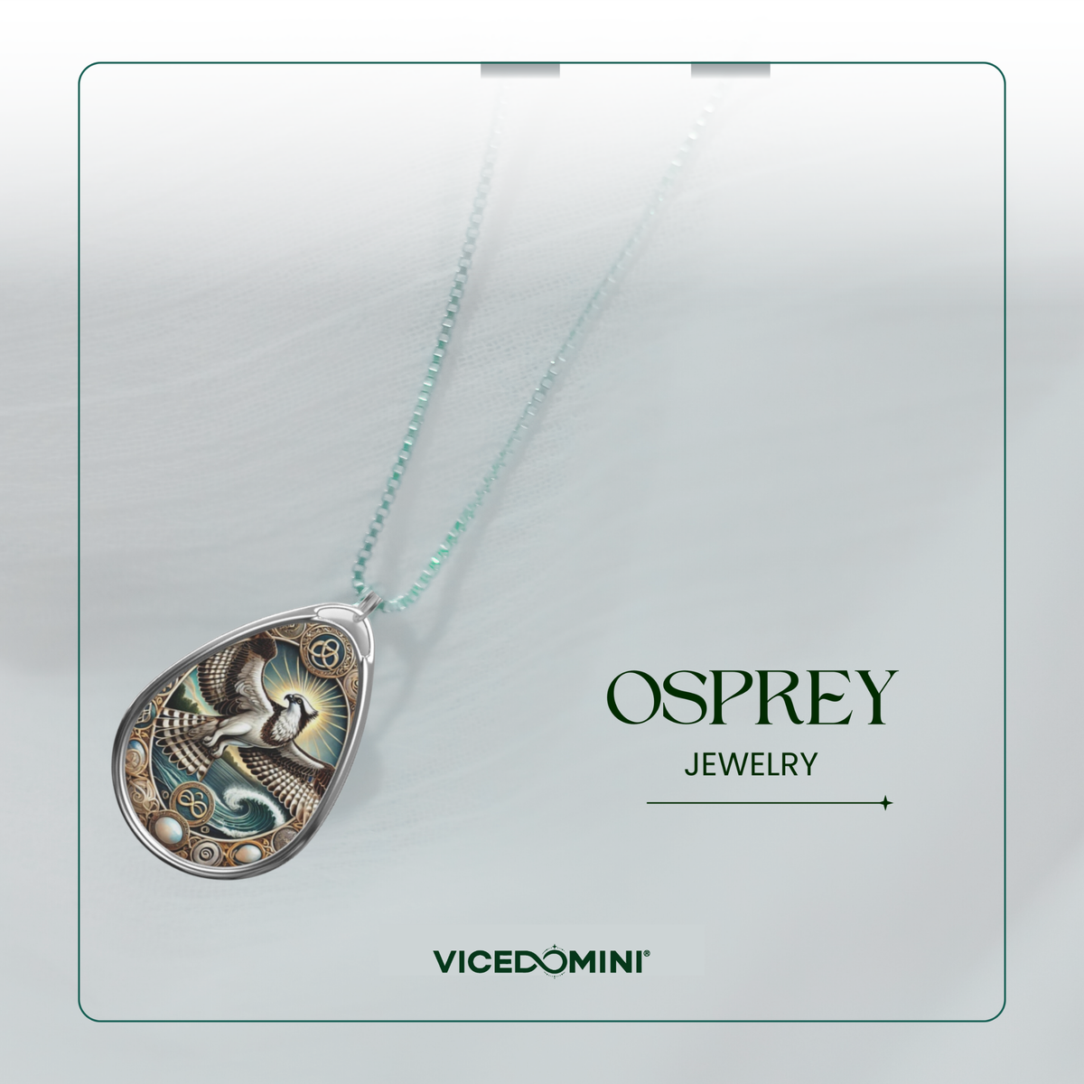 A teardrop-shaped pendant necklace from Vicedomini Osprey Jewelry, featuring an intricate silver-toned bird design with teal and gold accents on a light mint-green chain, presented on a clean light gray background with brand text.