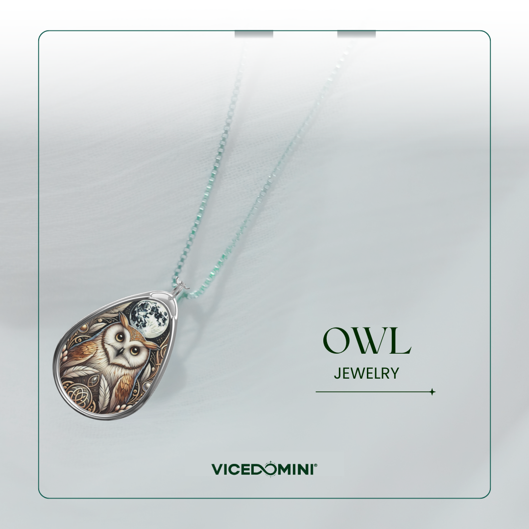 An owl pendant necklace by Vicedomini, featuring a detailed owl and moon design in silver and gold tones, suspended from a light mint-green chain against a soft gray background with 'OWL JEWELRY' and 'VICEDOMINI' text.