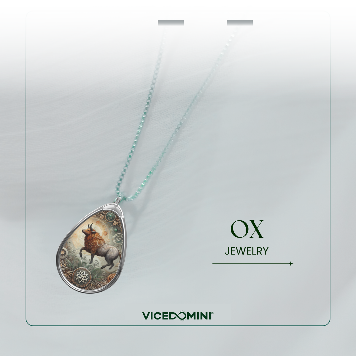 A teardrop-shaped pendant necklace with a silver-toned frame and a detailed illustration of a brown stag on a light background, hanging from a delicate mint-green chain. The image is presented on a white card with the text 'OX JEWELRY' and the brand 'VICEDOMINI' at the bottom.