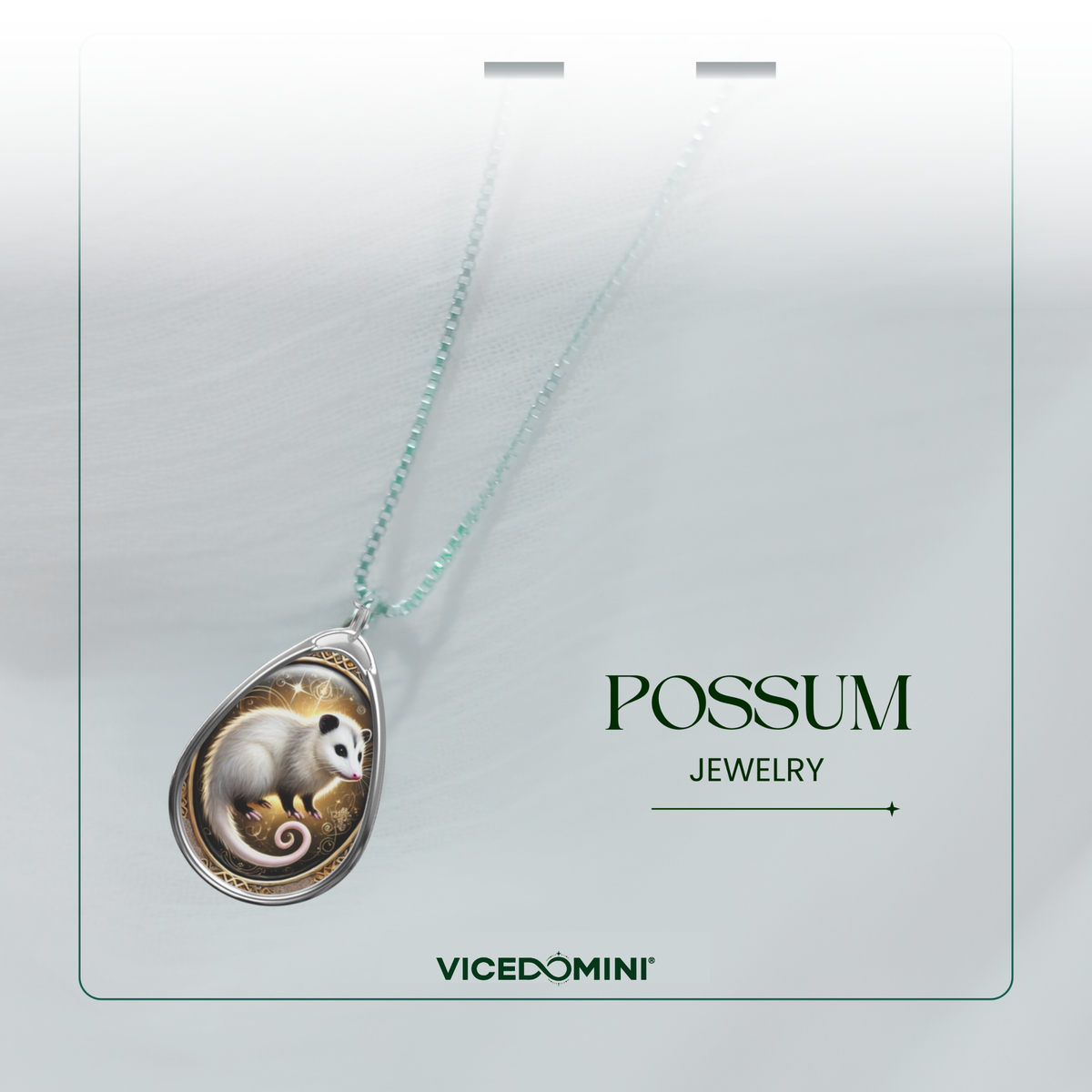A teardrop-shaped pendant necklace on a light mint chain, featuring an illustration of a white and brown mouse on a gold background, displayed on a branded card that reads 'POSSUM JEWELRY' and 'VICEDOMINI'.