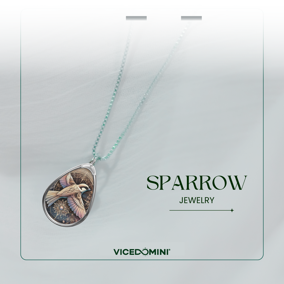A teardrop-shaped pendant necklace with a bird illustration, hanging from a delicate mint green chain. The pendant is displayed on a white card labeled 'SPARROW JEWELRY' and 'VICEDOMINI', with a soft-focus background.