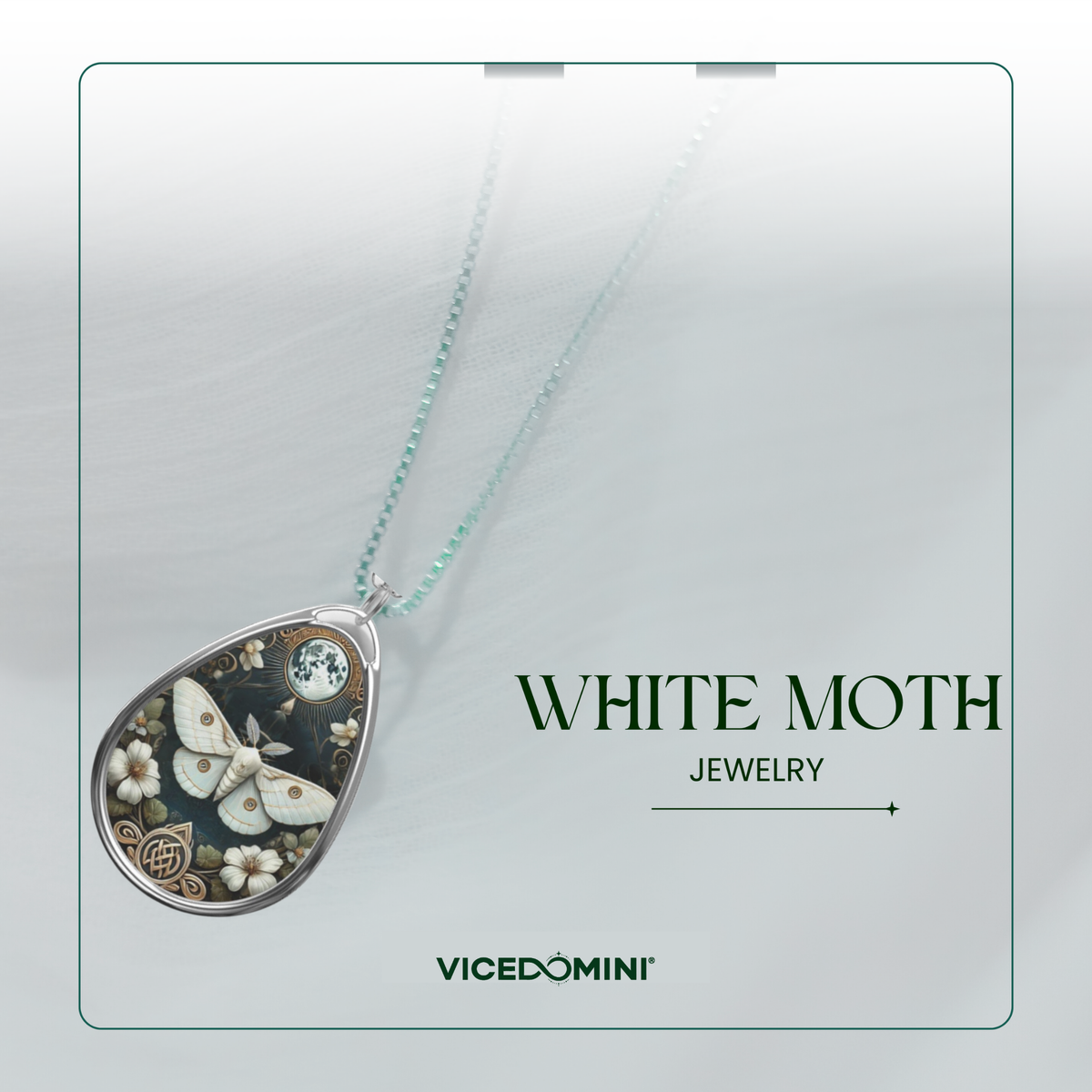 A teardrop-shaped pendant necklace from Vicedomini featuring a white moth and floral design set in silver, suspended on a light mint-green chain. The pendant is displayed against a soft gray background with a thin green border and text reading 'WHITE MOTH JEWELRY' and 'VICEDOMINI'.
