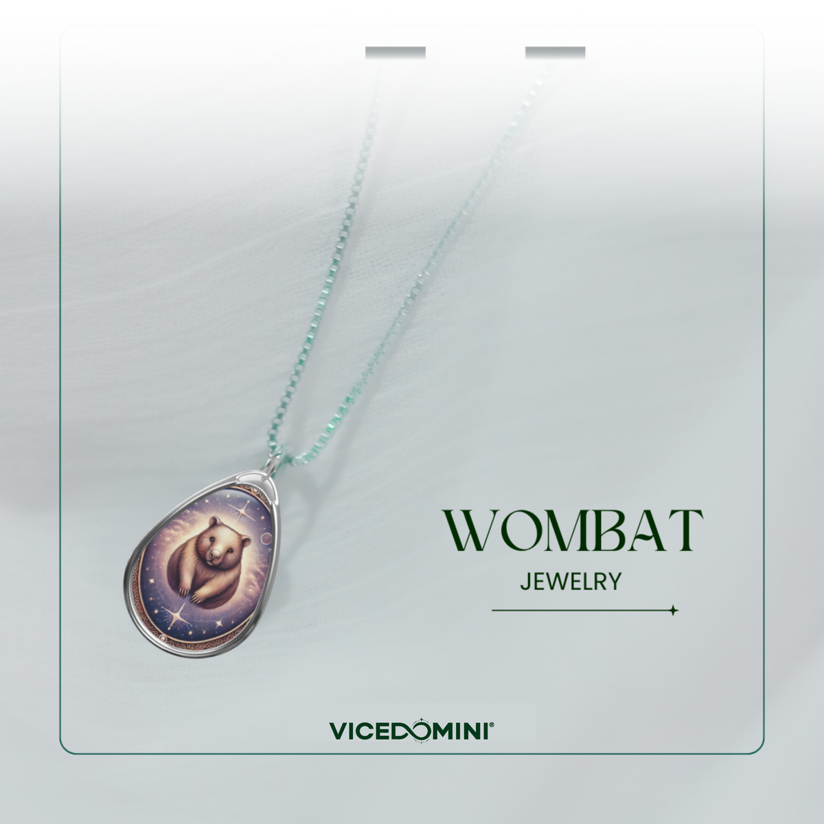 A teardrop-shaped pendant necklace on a light mint chain, displayed on a white jewelry card. The pendant features an illustration of a moose in a forest with a pentagram symbol, under the brand name Vicedomini and the collection name Moose Jewelry.