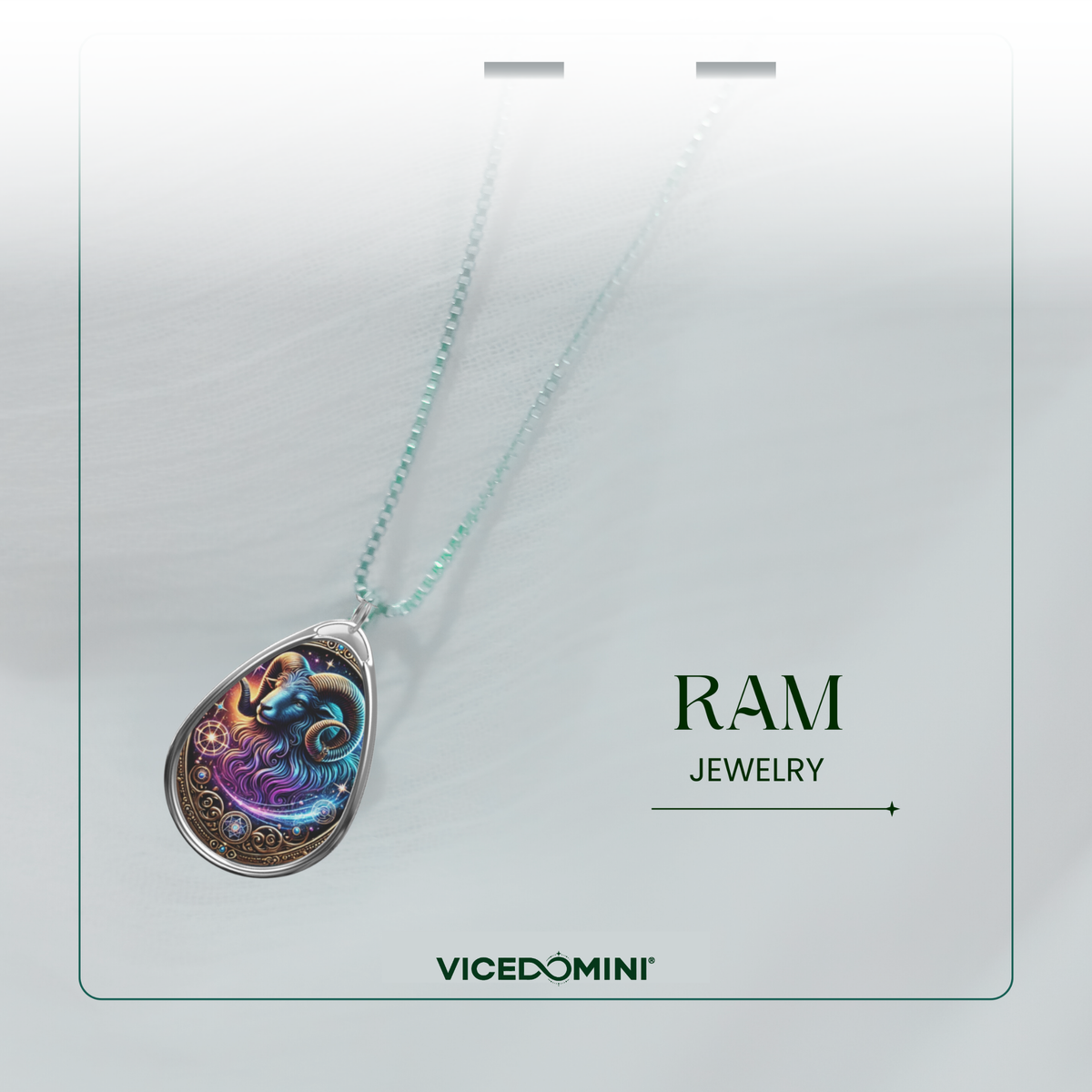 Close-up of a celestial-themed ram pendant necklace with an ethereal blue and purple ram illustration. The pendant is attached to a dainty silver chain and is displayed on a soft, white surface with the text 'RAM JEWELRY' and 'VICEDOMINI' written in green.