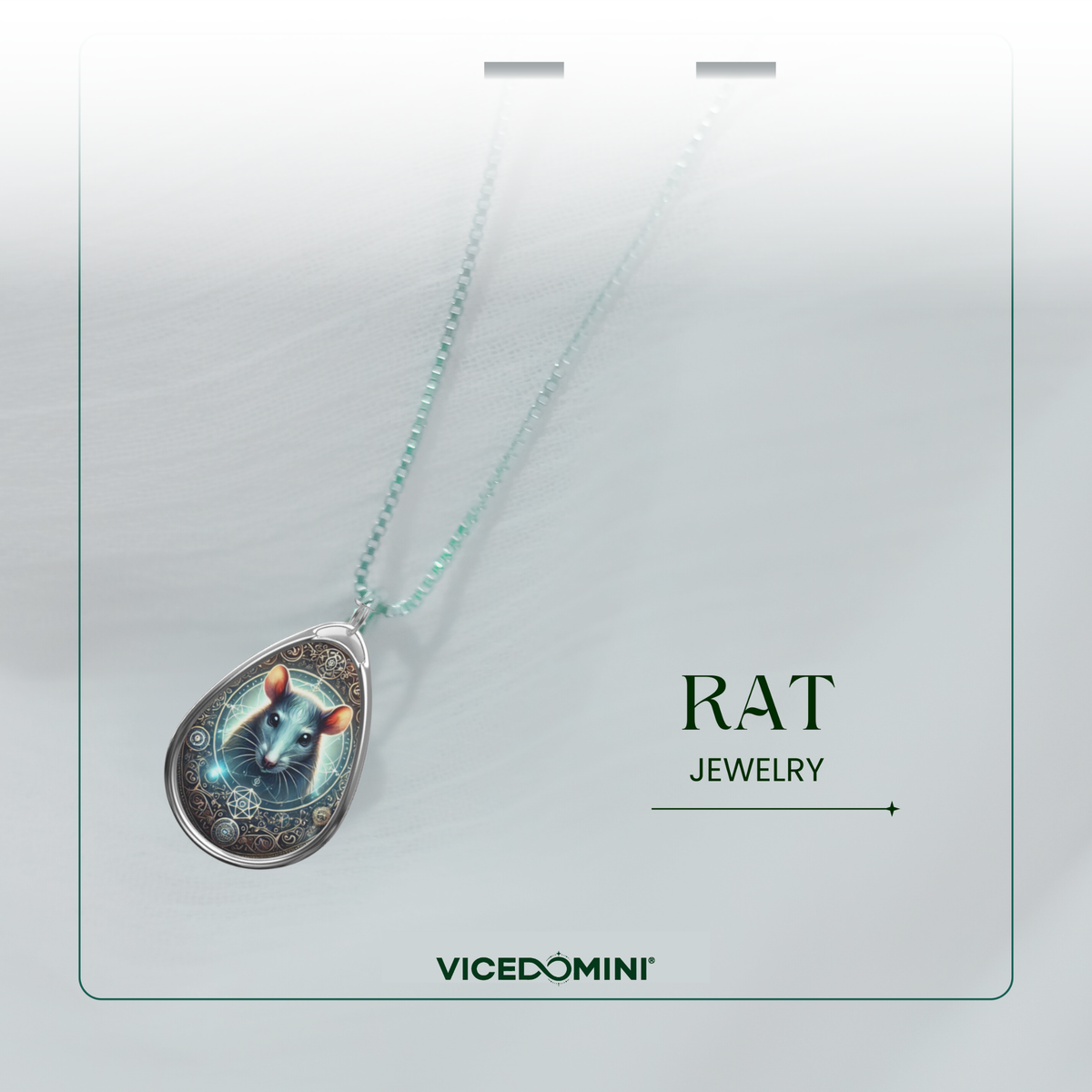A delicate silver necklace with a teardrop pendant featuring a glowing rat illustration, adorned with celestial and geometric motifs. The necklace is displayed against a light, airy fabric background with "RAT JEWELRY" and "VICEDOMINI" written below.