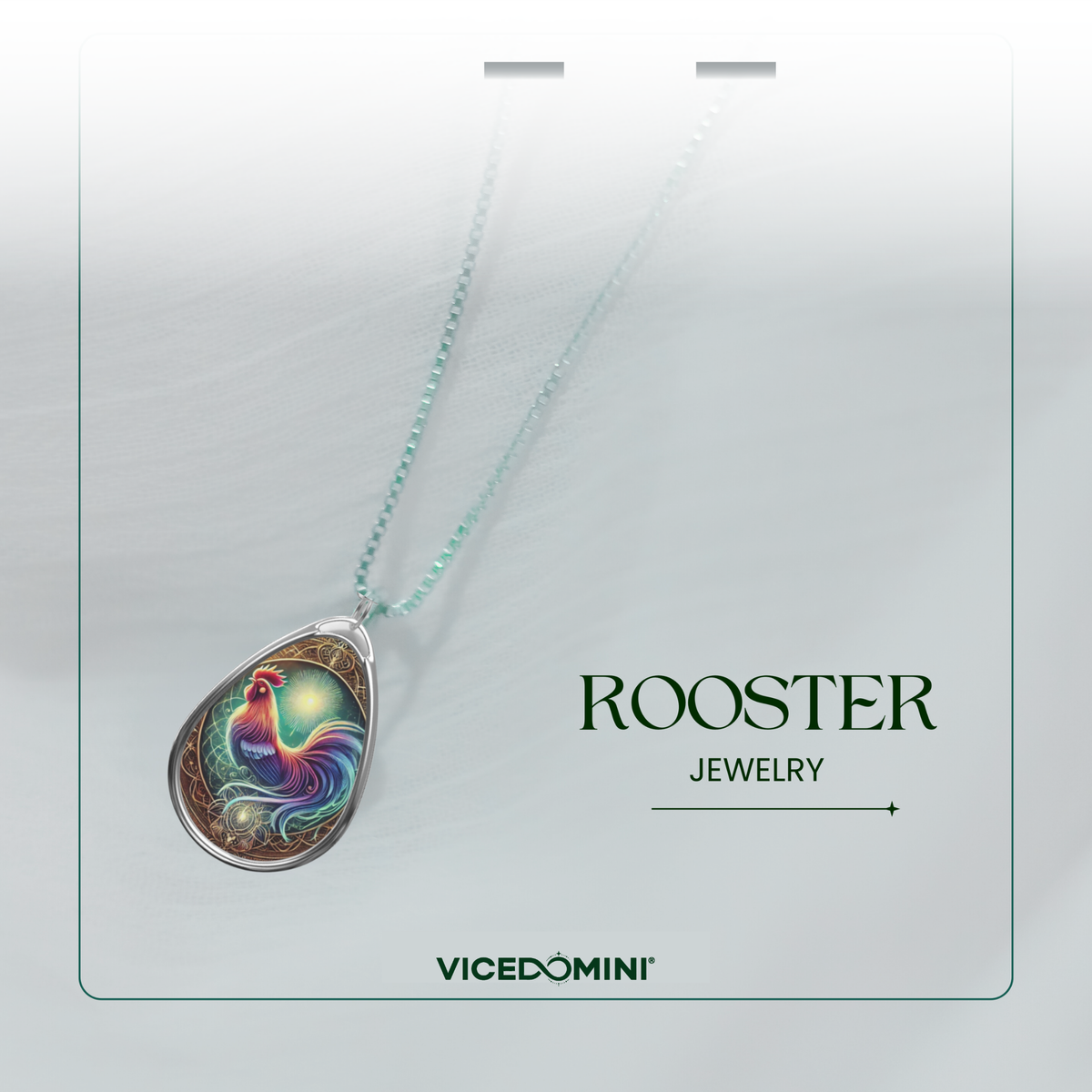 A close-up of the rooster pendant necklace, elegantly displayed on a light, airy background. The pendant’s intricate details include a multicolored rooster with a glowing aura, surrounded by ornamental patterns. The words "ROOSTER JEWELRY" and "VICEDOMINI" are placed beside it.