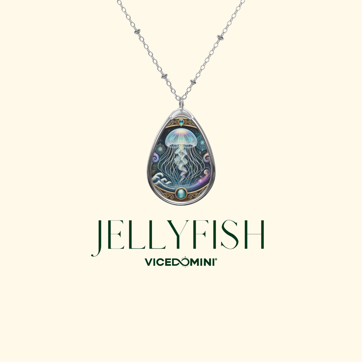 A silver teardrop pendant necklace featuring an intricate jellyfish illustration with blue, purple, and gold details, displayed on a cream background with the brand name 'VICEDOMINI' and 'JELLYFISH' text below.