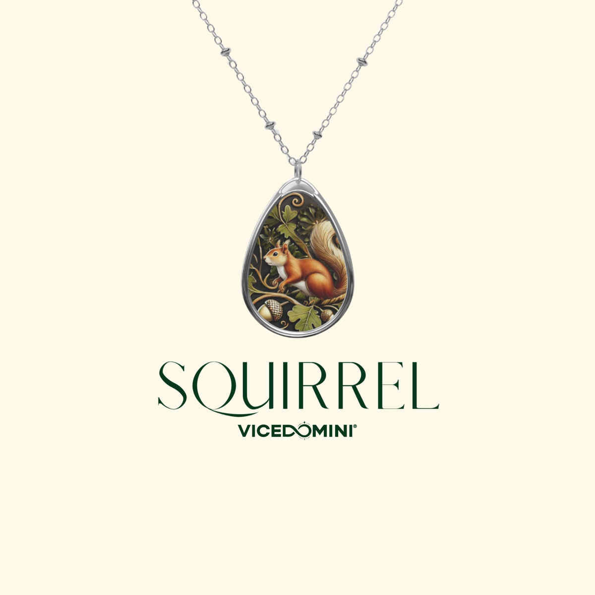 A silver teardrop pendant necklace featuring an illustrated squirrel on a tree branch, displayed against a light cream background with the brand name 'SQUIRREL Vicedomini' printed below.