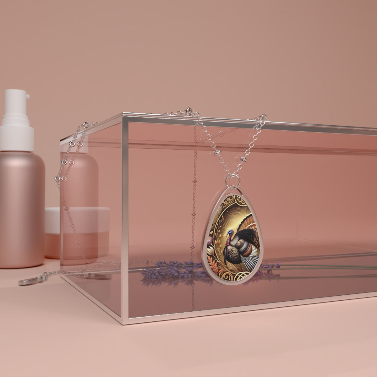 A silver necklace featuring a detailed turkey pendant draped over a clear box with lavender sprigs and cosmetics in the background, set against a soft pink backdrop. The pendant showcases a vibrant turkey with colorful feathers and intricate designs around the border.