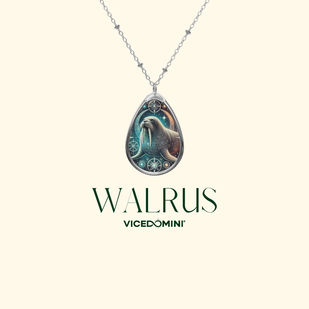 A  close-up of the walrus necklace suspended on a delicate silver chain against a minimalist cream background. The pendant features an ornate walrus illustration with starry and swirling details, accompanied by the text 'WALRUS - VICEDOMINI'.