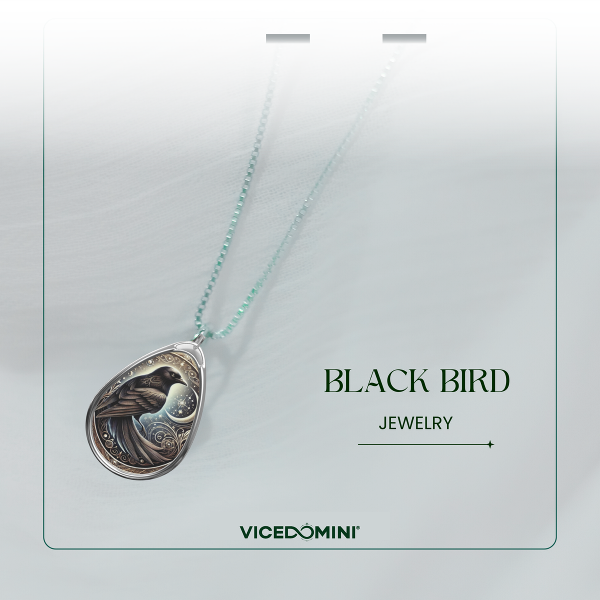 A close-up of the Black Bird Spirit Animal Necklace, highlighting the detailed engraving of a black bird against a starry night sky. The pendant is attached to a fine chain, with the words "Black Bird Jewelry" and the website "VICEDOMINI" displayed on the image.